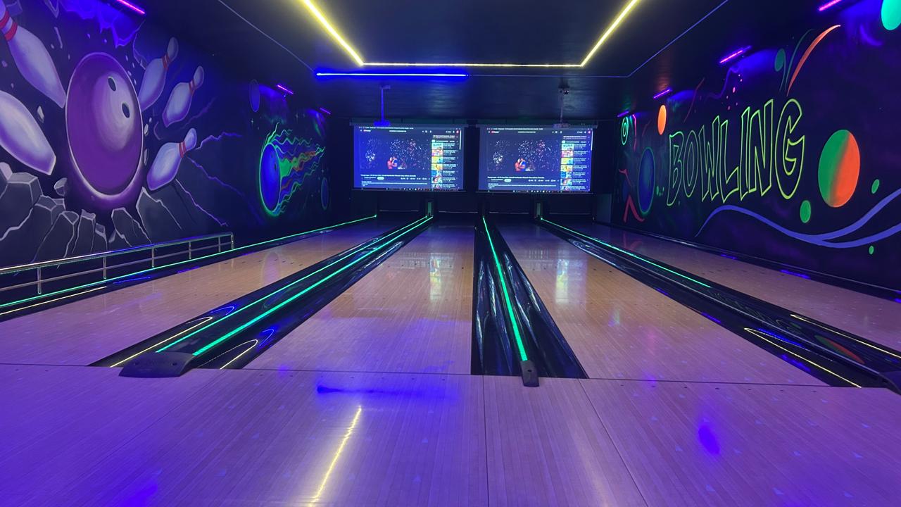 Glow in the dark bowling lanes with neon murals